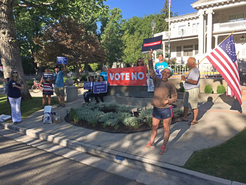About a dozen people gathered outside the Governor’s Mansion in Carson City on Wednesday, July 26, 2017, to protest changes to Obamacare being considered in the U.S. Senate. Sean Whaley/Las Vega ...