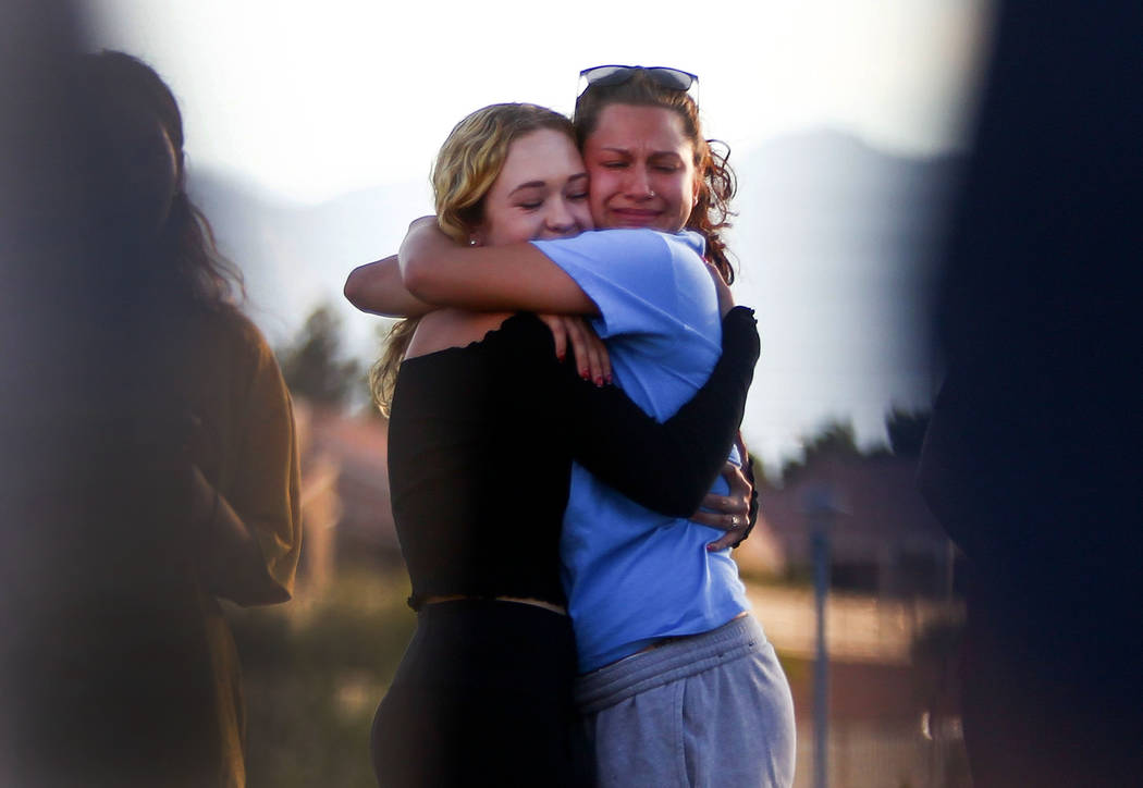 People embrace during a vigil for Haylei Hughes, a former Cimarron-Memorial student-athlete, who died in a hiking accident in Wash., at Kellogg Zaher Sports Complex in Las Vegas on Thursday, July ...