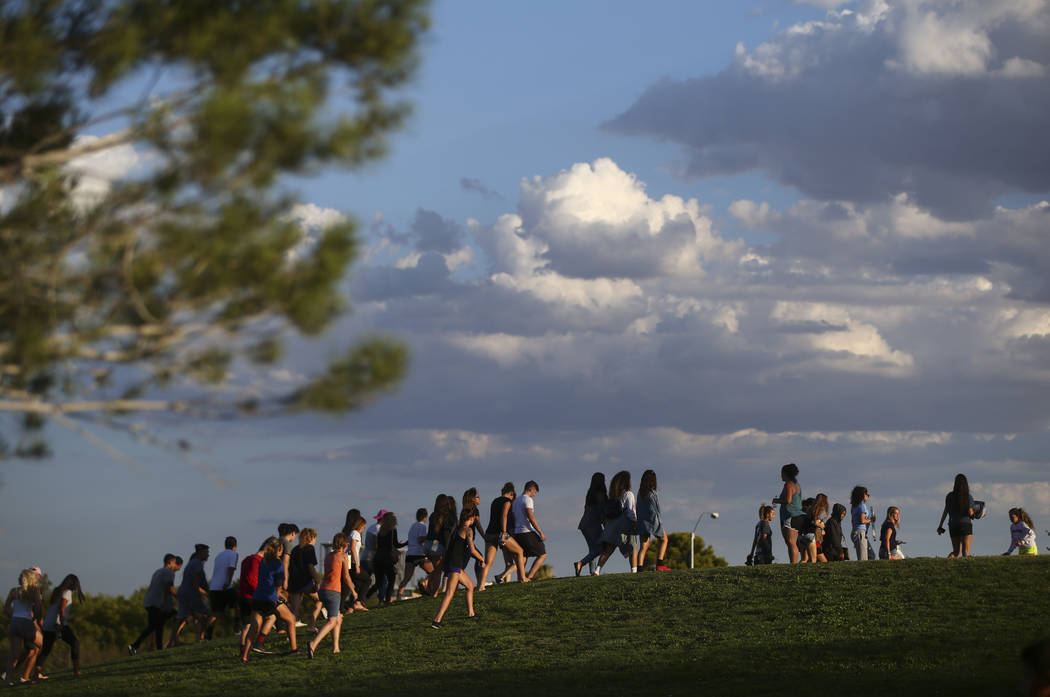 People gather for a vigil in memory of Haylei Hughes, a former Cimarron-Memorial student-athlete, who died in a hiking accident in Wash., at Kellogg Zaher Sports Complex in Las Vegas on Thursday, ...