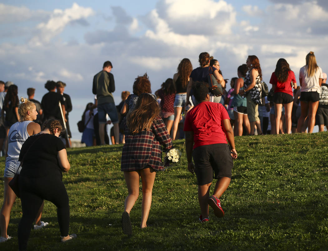People gather for a vigil in memory of Haylei Hughes, a former Cimarron-Memorial student-athlete, who died in a hiking accident in Wash., at Kellogg Zaher Sports Complex in Las Vegas on Thursday, ...