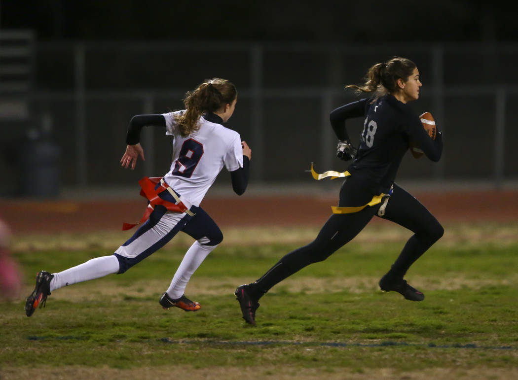Cimarron-Memorial's Haylei Hughes (18) runs for the end zone past Coronado's Caitlin Shannon (9) to score a touchdown on an interception during the Class 4A state championship flag football game a ...