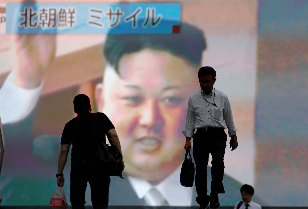 Men walk past a street monitor showing news of North Korea firing a ballistic missile, in Tokyo, Japan, July 4, 2017. Toru Hanai/Reuters