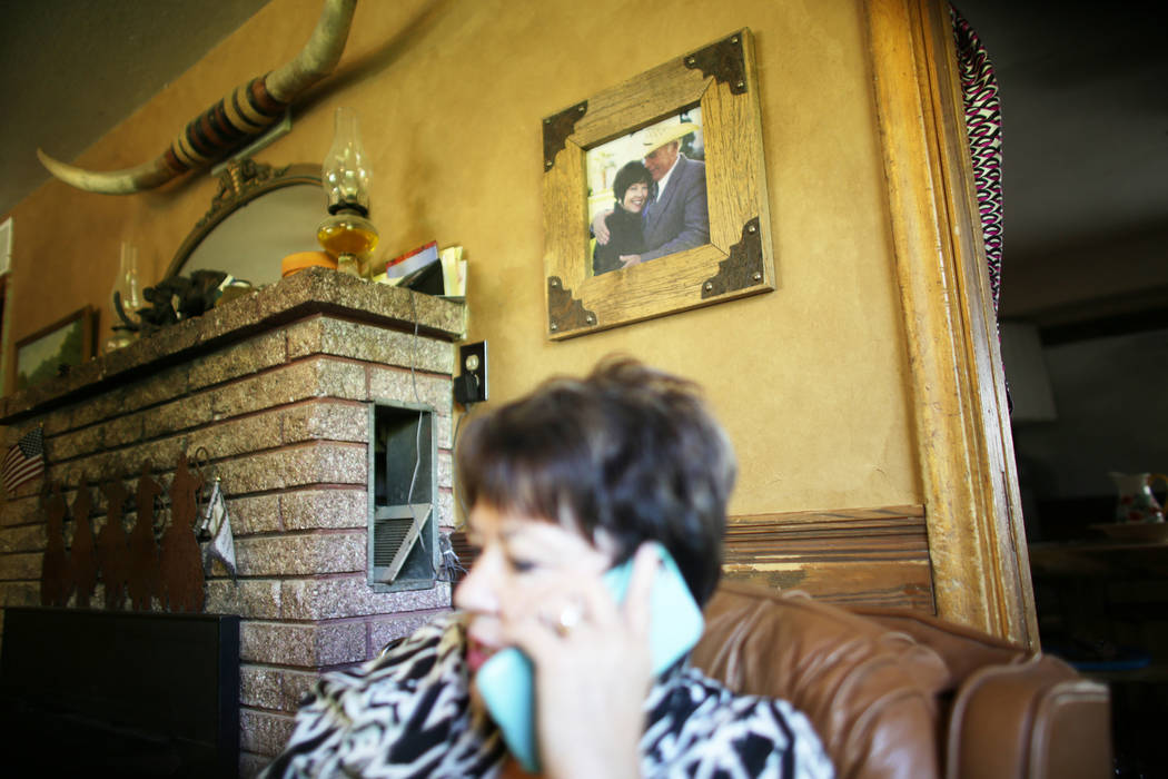 Carol Bundy speaks to Cliven Bundy on the phone at her ranch on Sunday, July 30, 2017, near Bunkerville. A photo of her and Cliven Bundy is on the wall. Interior Secretary Ryan Zinke is in the are ...