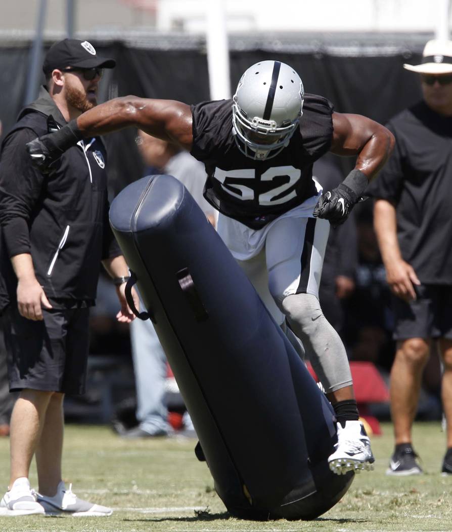 The Oakland Raiders defensive end Khalil Mack hits the tackling dummy during the second day of teams practice at Raiders Napa Valley training complex in Napa., Calif., on Sunday, July 30, 2017. Bi ...