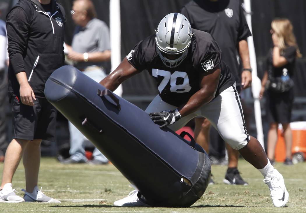 The Oakland Raiders defensive tackle Justin Ellis hits the tackling dummy during the second day of teams practice at Raiders Napa Valley training complex in Napa., Calif., on Sunday, July 30, 2017 ...