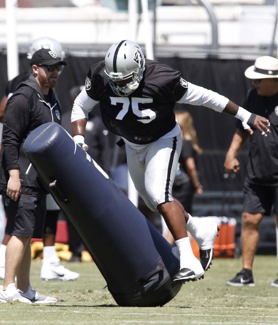 The Oakland Raiders defensive tackle Darius Latham hits the tackling dummy during the second day of teams practice at Raiders Napa Valley training complex in Napa., Calif., on Sunday, July 30, 201 ...
