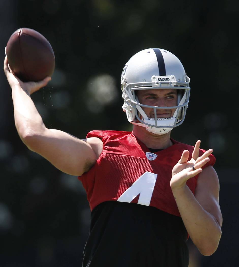 The Oakland Raiders quarterback Derek Carr prepares to pass the ball during the second day of teams practice at Raiders Napa Valley training complex in Napa., Calif., on Sunday, July 30, 2017. Biz ...