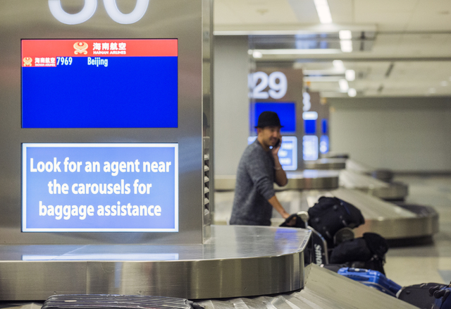 A passenger from a Hainan Airlines flight from Beijing exits baggage claim at McCarran International Airport on Wednesday, Jan. 11, 2017. (Jeff Scheid/Las Vegas Review-Journal) @jeffscheid