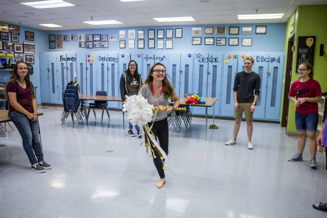 Student council secretary Devon Neary, center, prods at her fellow members with a decorative pool noodle while playing an icebreaker game in preparation for an upcoming retreat at Bonanza High Sch ...