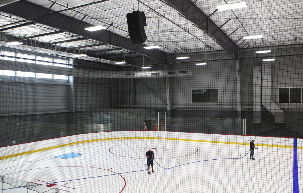 Members of the ice crew put on the finishing touches on the ice surface of one of two ice rinks at City National Arena, the Vegas Golden Knights' headquarters and training facility, in Las Vegas o ...