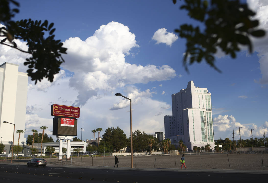 People walk by the lot where The Clarion Hotel and Casino once stood on Convention Center Drive in Las Vegas on Wednesday, Aug. 2, 2017. Chase Stevens Las Vegas Review-Journal @csstevensphoto