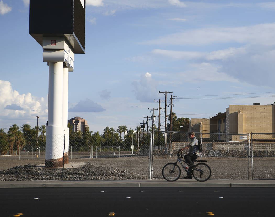A cyclist passes by the lot where The Clarion Hotel and Casino once stood on Convention Center Drive in Las Vegas on Wednesday, Aug. 2, 2017. Chase Stevens Las Vegas Review-Journal @csstevensphoto