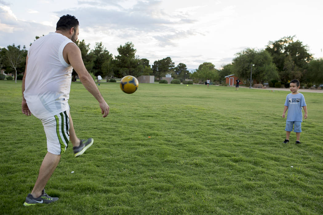 Roberto Barajas plays soccer with his son Bryan Barajas at Sunset Park in Las Vegas on Tuesday, Aug. 1, 2017. Bridget Bennett Las Vegas Review-Journal @bridgetkbennett