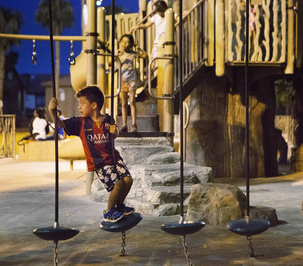 Kids play on a playground at Sunset Park in Las Vegas on Tuesday, Aug. 1, 2017. Bridget Bennett Las Vegas Review-Journal @bridgetkbennett