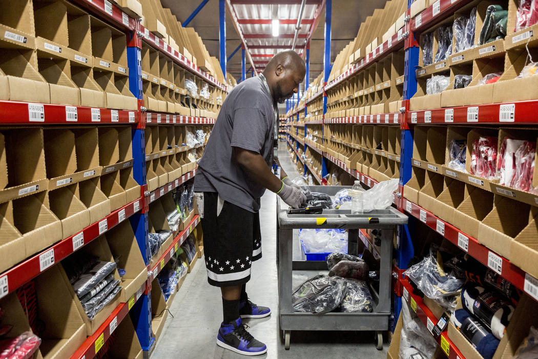 Warehouse employee Charles Williams organizes apparel at the Fanatics distribution center in North Las Vegas, Wednesday, Aug. 16, 2017. (Elizabeth Brumley/Las Vegas Review-Journal)