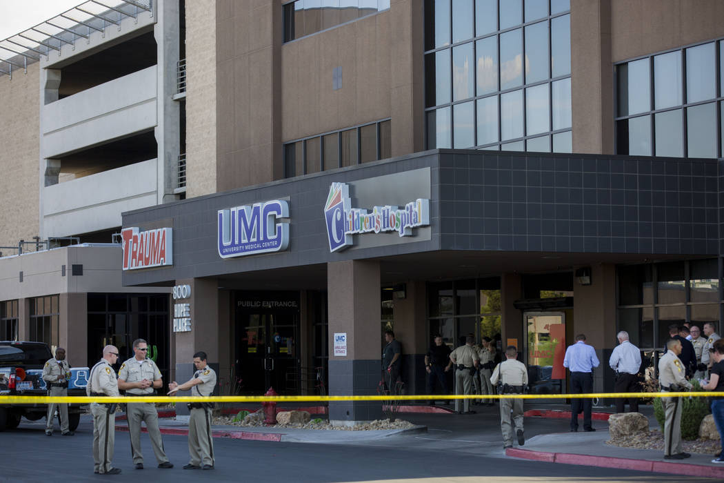 Police officers gather in front of University Medical Center to support the injured Metro officer, Tuesday, August 1, 2017, after an officer-involved shooting at the intersection of Tompkins Avenu ...
