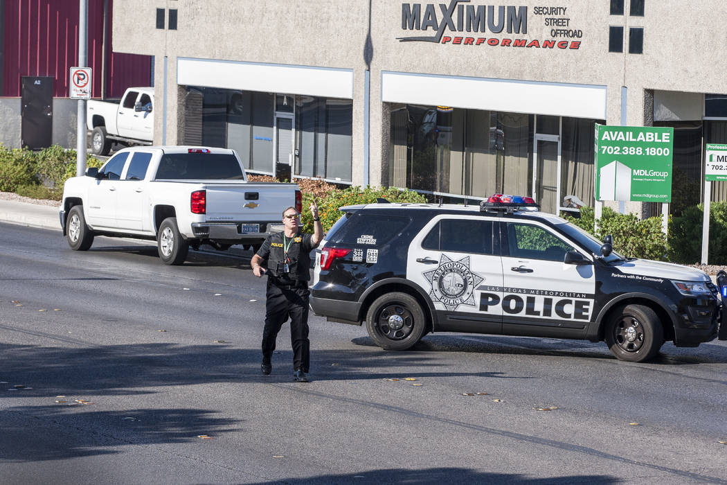 A police officer stands by curisers on Arville Street after an officer-involved shooting in which an officer was injured on Tuesday, August 1, 2017.  Patrick Connolly Las Vegas Review-Journal @PCo ...