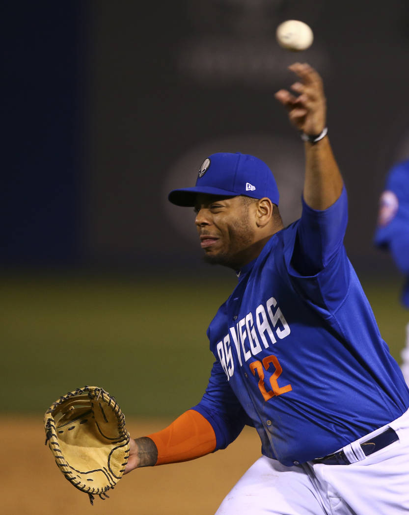 Las Vegas 51s first baseman Dominic Smith (22) throws to home base for the out during a baseball game at Cashman Field in Las Vegas on Thursday, April 13, 2017. Chase Stevens Las Vegas Review-Jour ...