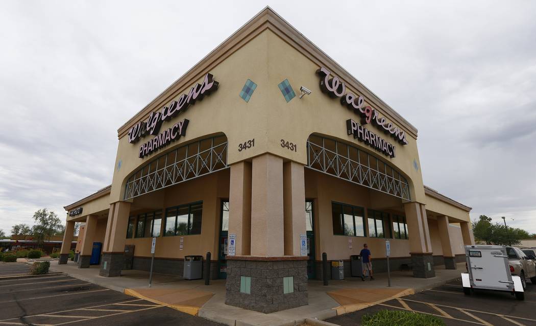 A local Walgreens remains closed Wednesday, Aug. 2, 2017, in Phoenix, after a customer at the drugstore shot and killed a man who was attempting to rob the pharmacy Tuesday night, according to pol ...