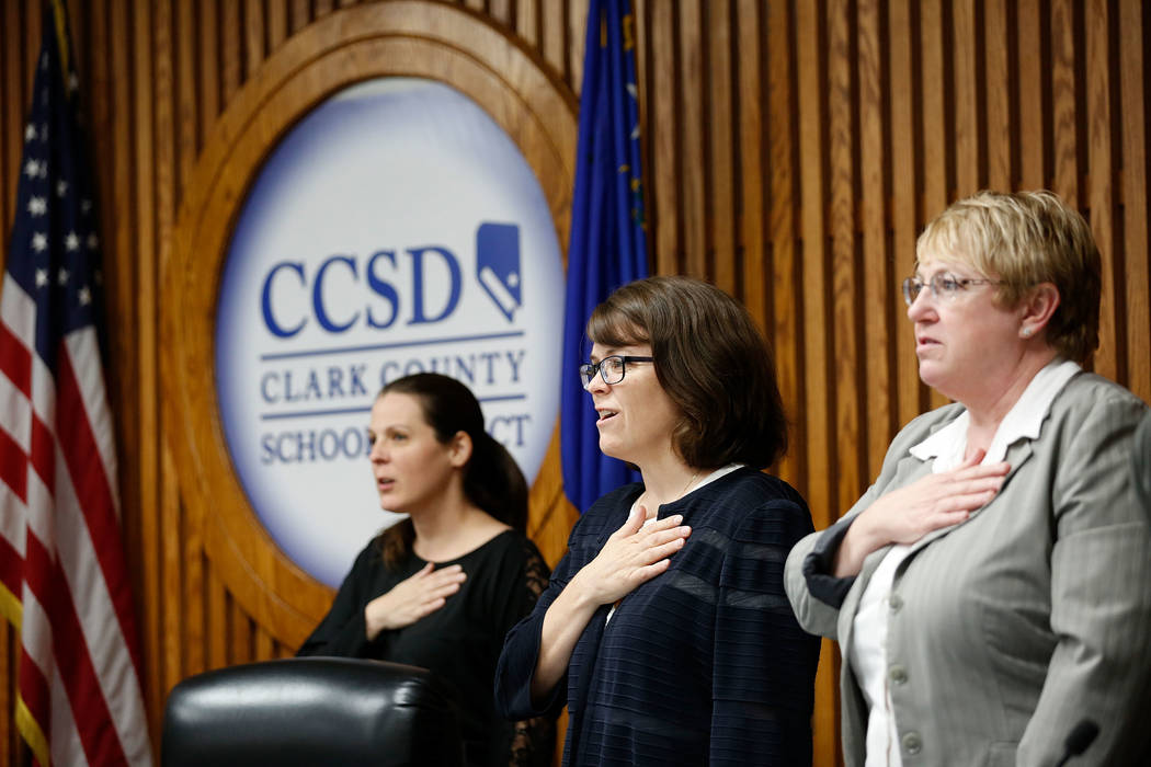 Members of the Clark County School Board including Lola Brooks, left, Erin Cranor and Chris Garvey during the Pledge of Allegiance before a meeting at Edward Greer Education Center in Las Vegas, T ...