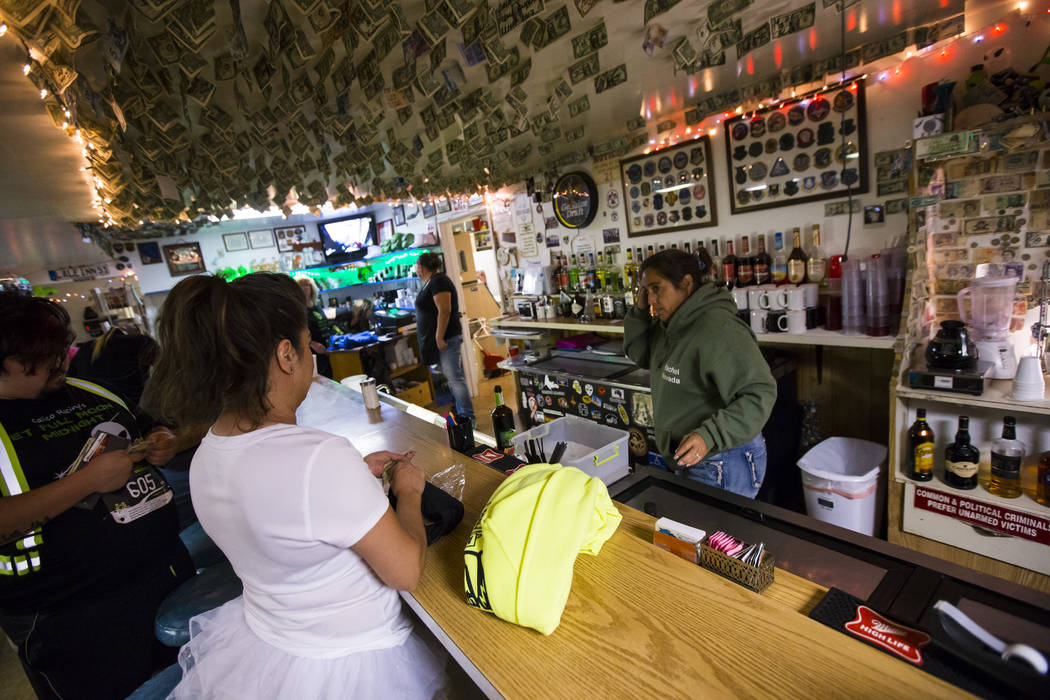 Lisa Anderson of Los Angeles, left, buys a sweatshirt before participating in th Extraterrestrial Full Moon Midnight Marathon in Rachel on Saturday, Aug. 5, 2017. The event featured five distances ...