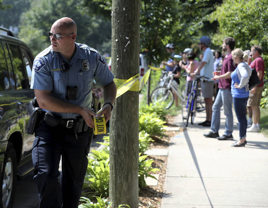 A Minneapolis police officer puts up police tape following an explosion at Minnehaha Academy Wednesday, Aug. 2, 2017, in Minneapolis. (David Joles/Star Tribune via AP)