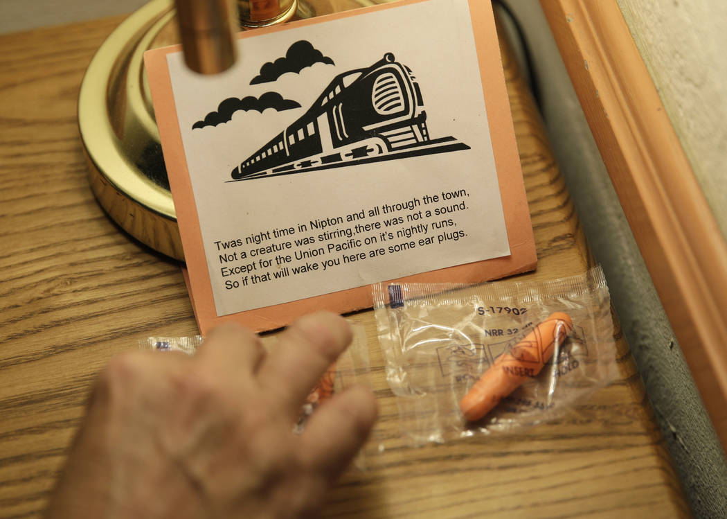 Laura Cavaness places earplugs to block out noise from passing trains in a room at the Hotel Nipton, Thursday, Aug. 3, 2017, in Nipton, Calif. American Green Inc., one of the nation's largest cann ...