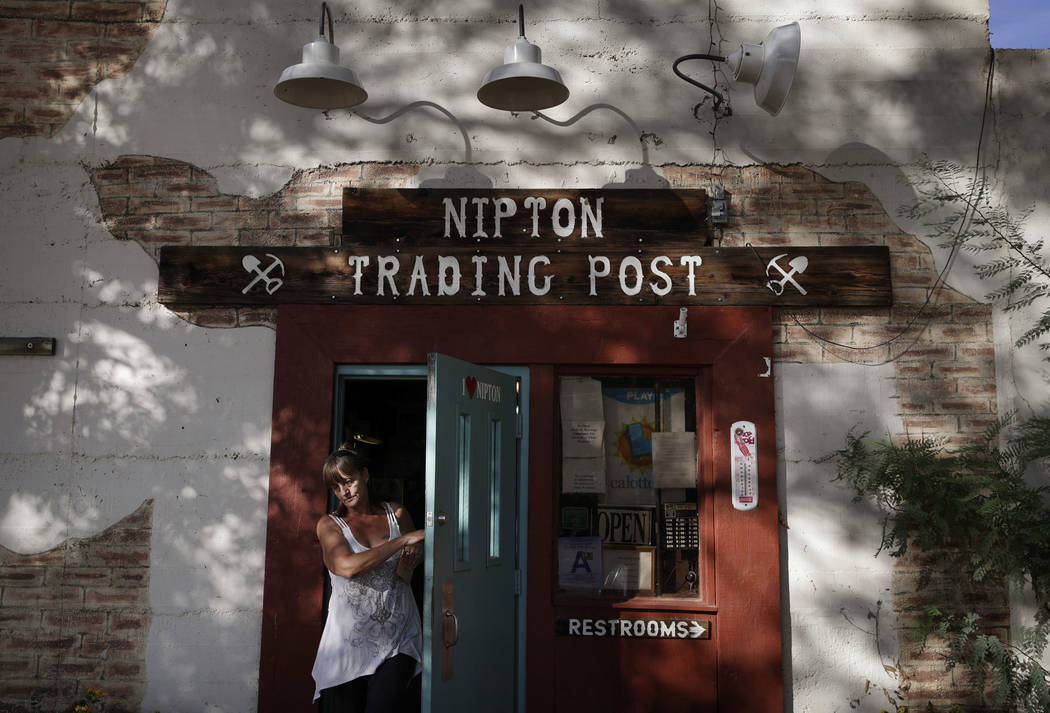 A woman leaves the Nipton Trading Post, Thursday, Aug. 3, 2017, in Nipton, Calif. American Green Inc., one of the nation's largest cannabis companies, announced it has bought the entire 80 acre Ca ...