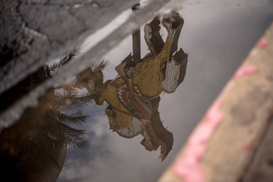 A reflection of a neon sign in a street puddle along Las Vegas Blvd. on Friday, August 4, 2017, in Las Vegas. Morgan Lieberman Las Vegas Review-Journal