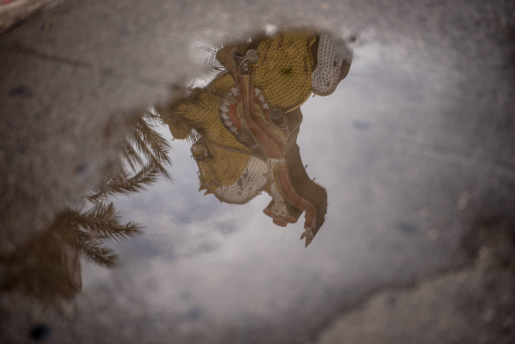 A reflection of a neon sign in a street puddle along Las Vegas Blvd. on Friday, August 4, 2017, in Las Vegas. Morgan Lieberman Las Vegas Review-Journal