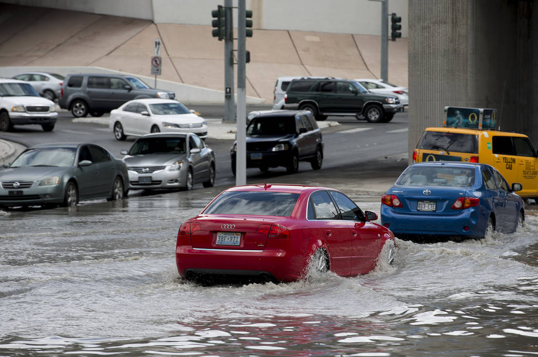 Drivers attempt to navigate a flooded area near the intersection of Dean Martin Drive and West Twain Ave on Friday, Aug. 4, 2017, in Las Vegas. Bridget Bennett Las Vegas Review-Journal @bridgetkbe ...