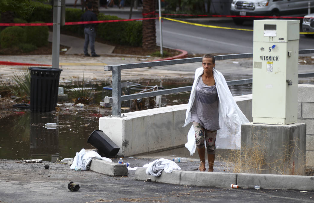 A woman who appears to have been rescued from the wash behind The Linq Hotel in Las Vegas on Friday, Aug. 4, 2017. Six people were rescued from the wash. Chase Stevens Las Vegas Review-Journal @cs ...