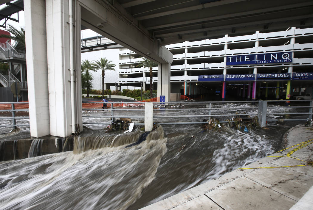 Water flows through the wash behind The Linq Hotel in Las Vegas on Friday, Aug. 4, 2017. Six people were rescued from the wash. Chase Stevens Las Vegas Review-Journal @csstevensphoto