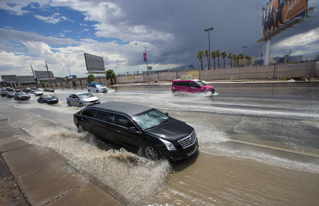 Traffic passes through floodwaters along Swenson Street near Tropicana Avenue in Las Vegas on Friday, Aug. 4, 2017. Chase Stevens Las Vegas Review-Journal @csstevensphoto