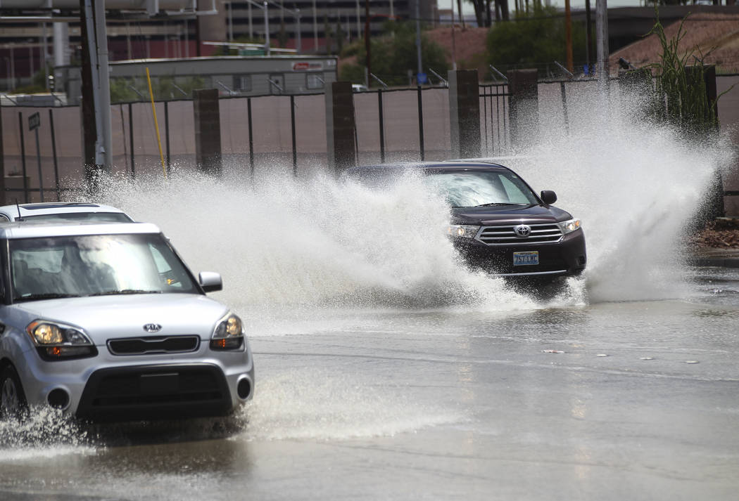Traffic passes through floodwaters along Swenson Street near Tropicana Avenue in Las Vegas on Friday, Aug. 4, 2017. Chase Stevens Las Vegas Review-Journal @csstevensphoto