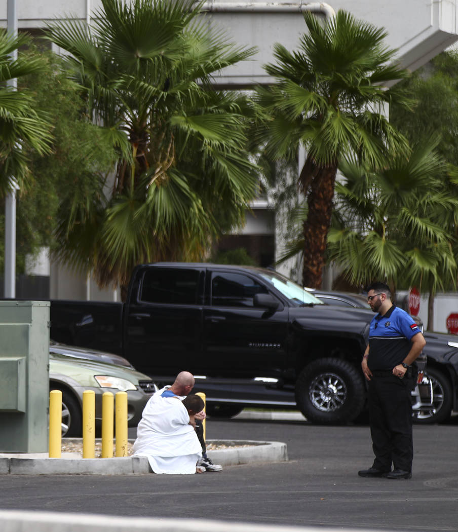 Two people who appear to have been rescued from the wash behind The Linq Hotel in Las Vegas on Friday, Aug. 4, 2017. Six people were rescued from the wash. Chase Stevens Las Vegas Review-Journal @ ...