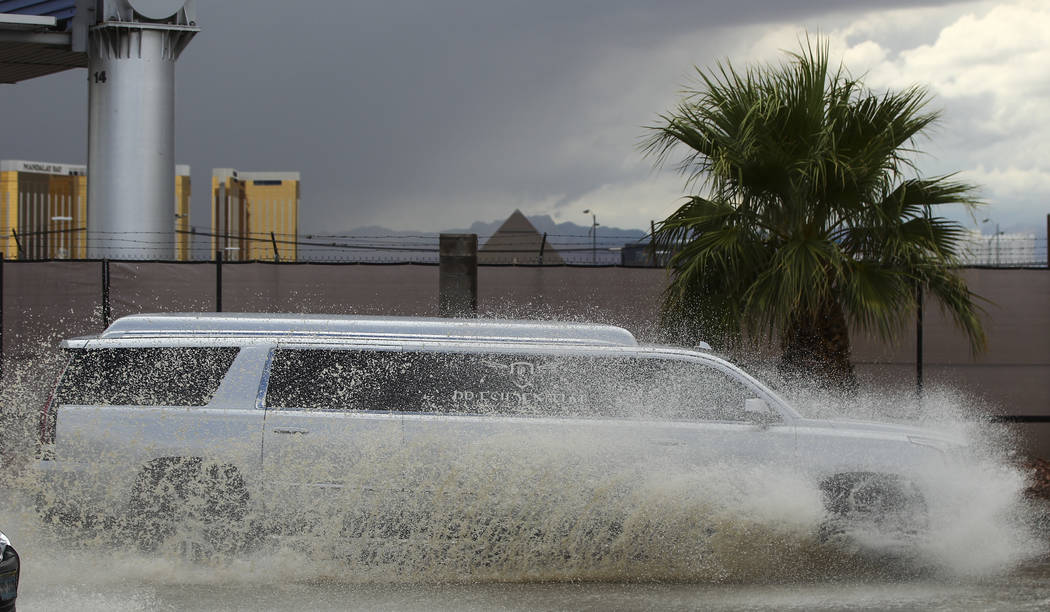 Traffic passes through floodwaters along Swenson Street near Tropicana Avenue in Las Vegas on Friday, Aug. 4, 2017. Chase Stevens Las Vegas Review-Journal @csstevensphoto