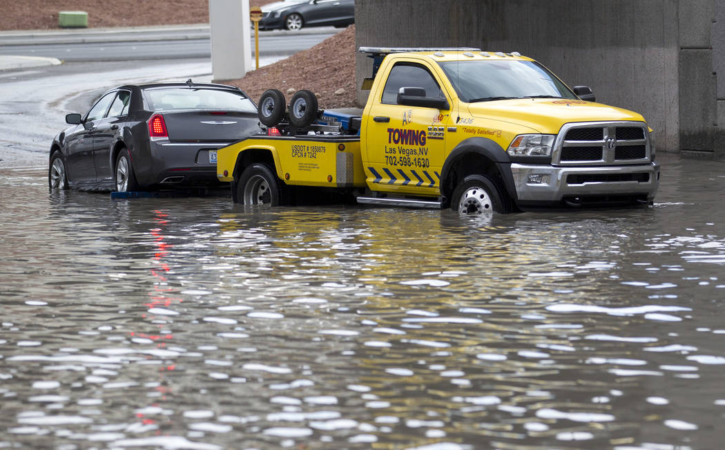 A tow truck pulls a vehicle from flood waters on West Twain Avenue near Dean Martin Drive following rain fall on Friday, August 4, 2017, in Las Vegas. Richard Brian Las Vegas Review-Journal @vegas ...