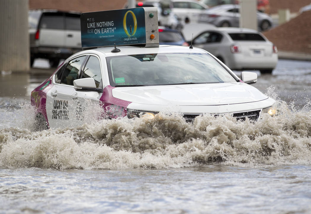A taxi drives through flood waters on West Twain Avenue near Dean Martin Drive following rain fall on Friday, August 4, 2017, in Las Vegas. Richard Brian Las Vegas Review-Journal @vegasphotograph