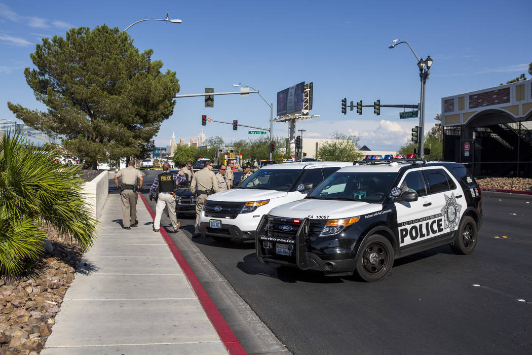 Las Vegas police congregate near the intersection of Tompkins Avenue and Arville Street after an officer-involved shooting in which an officer was injured on Tuesday, August 1, 2017.  (Patrick Con ...