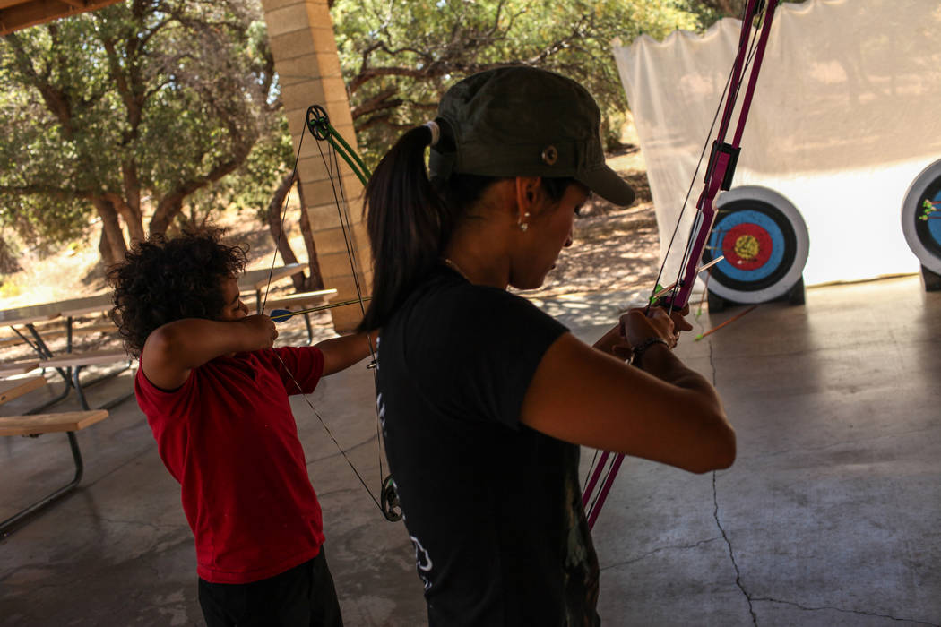 Andrew Greenman, 10, and Raquel Adams practice during an archery target shooting program at Spring Mountain Ranch State Park near Blue Diamond on Aug. 25, 2017. Joel Angel Juarez Las Vegas Review- ...