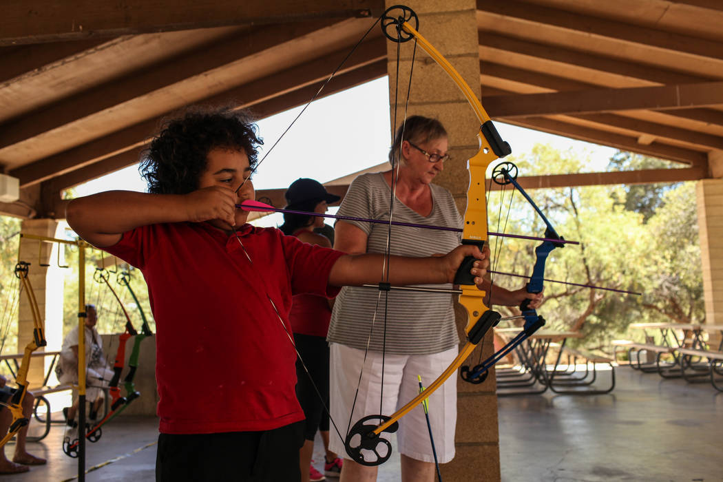 Andrew Greenman, 10, and Edie Duncan practice during an archery target shooting program at Spring Mountain Ranch State Park near Blue Diamond on Aug. 25, 2017. Joel Angel Juarez Las Vegas Review-J ...