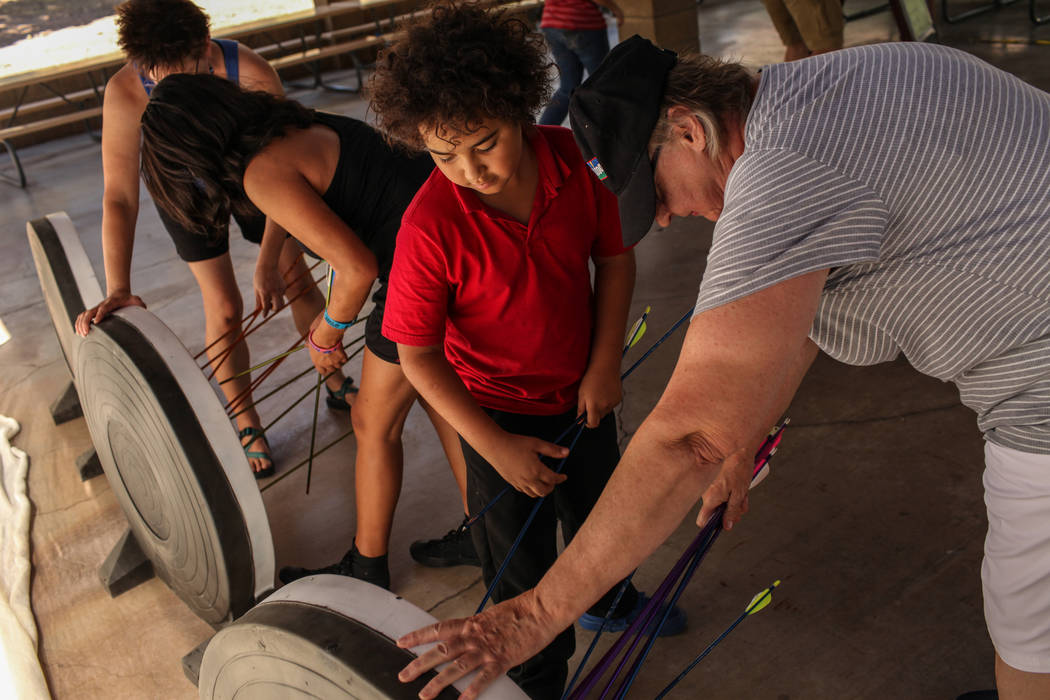 Andrew Greenman, 10, and Edie Duncan retrieve arrows during an archery target shooting program at Spring Mountain Ranch State Park near Blue Diamond on Aug. 25, 2017. Joel Angel Juarez Las Vegas R ...