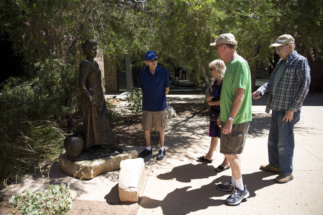 James Kingery, from left, his wife Susan and friends Jeffrey and Stephen Alpert, brothers, look at a statue of Helen Jane Wiser Stewart during a tour the Old Las Vegas Mormon Fort in Las Vegas, on ...