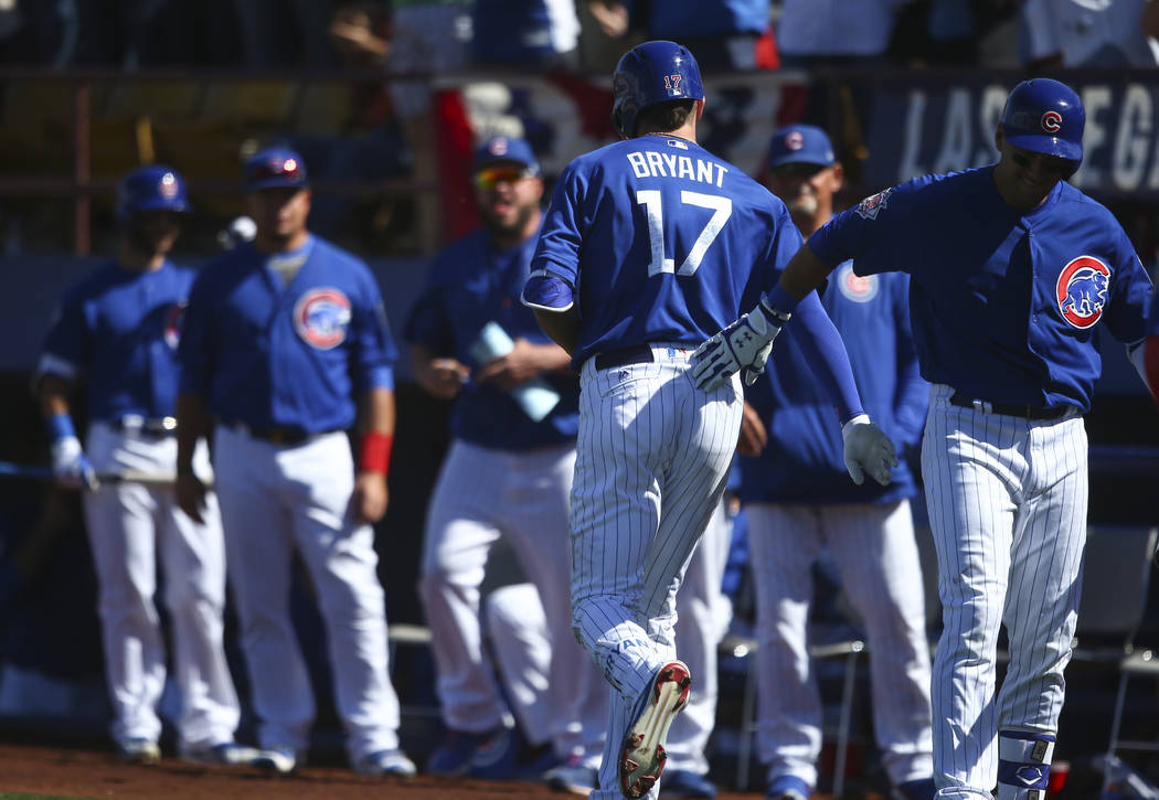 Chicago Cubs' Kris Bryant (17) returns to the dugout after scoring a home run against the Cincinnati Reds during their Big League Weekend baseball game at Cashman Field in Las Vegas on Saturday, M ...