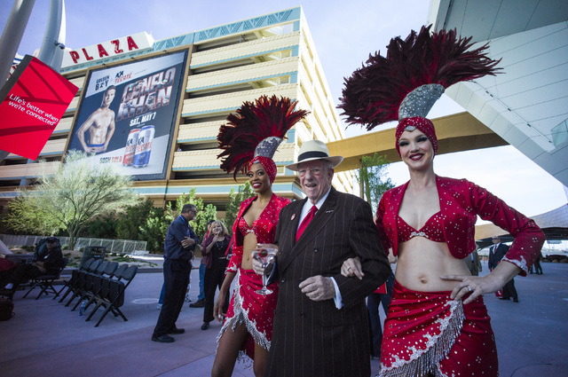 Oscar Goodman, with showgirls Trisha Thompson, left, and Kristina Schiavi for a rally celebrating National Travel & Tourism Week at Toshiba Plaza in Las Vegas on Tuesday, May 3, 2016. Chase St ...