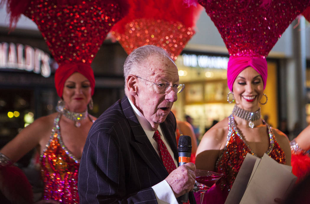 Former Las Vegas Mayor Oscar Goodman hands out prizes to the crowd with the help of a few Viva Las Vegas Showgirls during a celebration of tourism hosted by the Las Vegas Convention and Visitors A ...