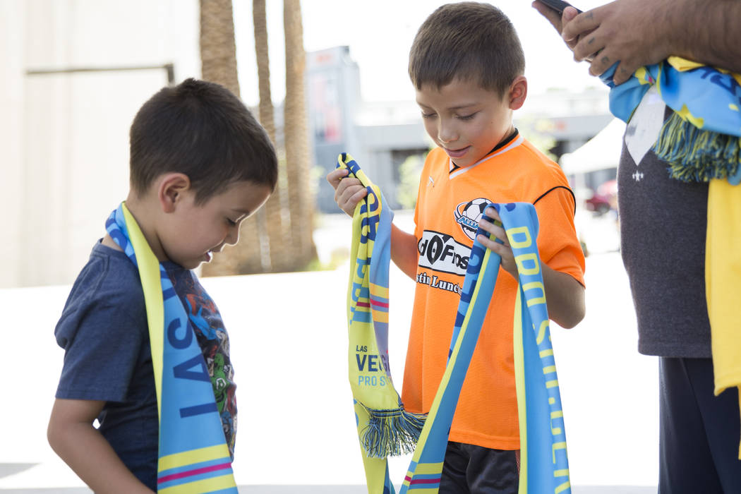 Alexander Vargas, 5, left, and his brother Emmanuel, wear Las Vegas Pro Soccer scarves during an United Soccer League event to celebrate the newest team in the league at the Zappos campus in Las V ...