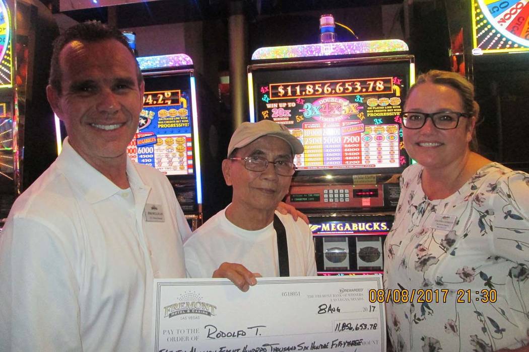 Jackpot winner Rodolfo T., center, receives a check from Fremont vice president and general manager Jim Sullivan and slot director Salinda Conklin, Tuesday, Aug. 8, 2017. Rodolfo won $11.8 million ...