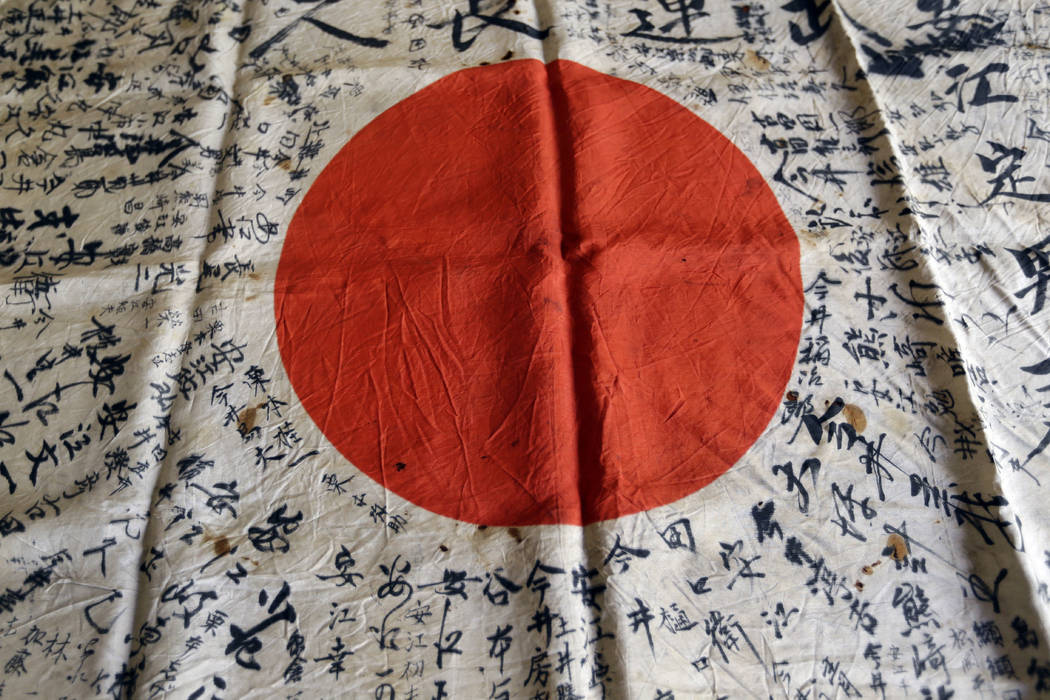 In this Monday, Aug. 7, 2017 photo, names are visible on a Japanese flag owned by WWII veteran Marvin Strombo in Portland, Ore. Strombo recovered the flag from a dead Japanese soldier in the Pacif ...